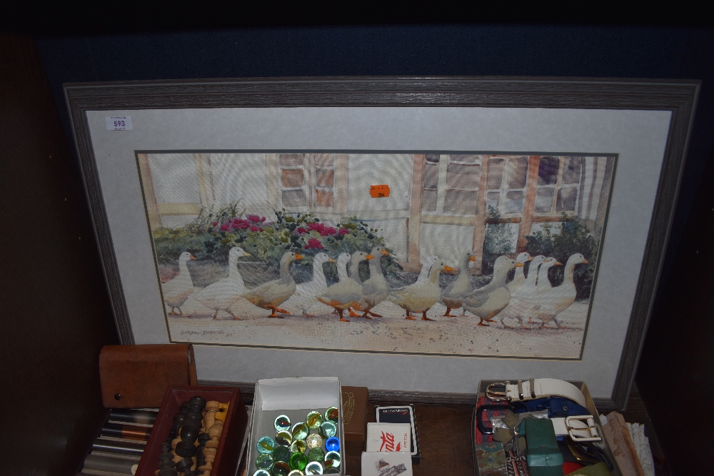 A partially embroidered frame and glazed picture of geese and house scene.