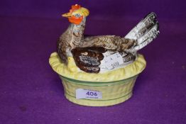 An antique porcelain egg nest in the form of a chicken hand painted and glazed in good condition