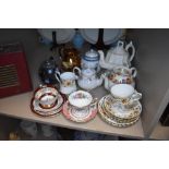 A selection of teapots and teacups including Delhi and Royal Albert