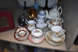 A selection of teapots and teacups including Delhi and Royal Albert