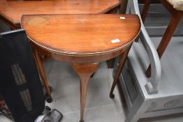 A 1950s demi lune hall table, width approx. 61cm