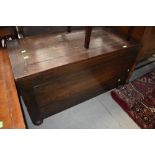 An early 20th Century oak bedding box having flat top and bun feet, dimensions approx. 99 x 46 x