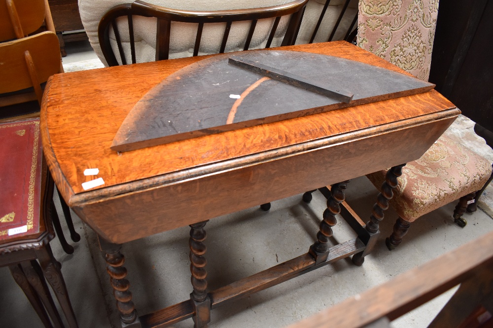 An early to mid 20th Century oak twist gate leg dining table, leaf damaged but present