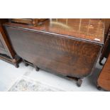 An early 20th Century oak gateleg dining table having barley twist frame, width approx 107cm, open