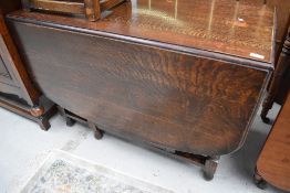 An early 20th Century oak gateleg dining table having barley twist frame, width approx 107cm, open