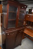 An early 20th shallow bookcase, with double cupboard under, width approx. 78cm