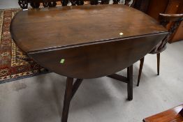 An Ercol dark stained drop leaf dining table