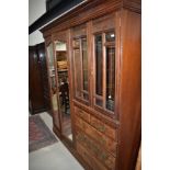 A late Victorian or Edwardian mahogany and walnut master robe of large proportions, comprising