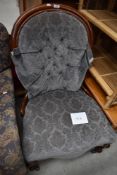 A Victorian ballon back nursing chair on knurl legs , having later upholstery