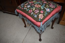 An early to mid 20th Century woolwork footstool having stained frame and cabriole legs, approx. 50 x