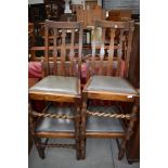 Four early 20th Century oak dining chairs having rail back and barley twist front stretcher (