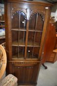 A Priory style oak corner display with cupboard under havjng linenfold door