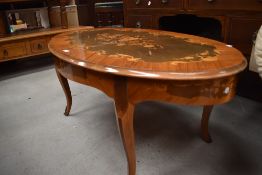 A Continental style oval coffee table having brass embellishments to legs, width approx. 116cm