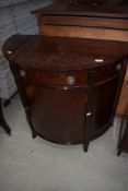 A reproduction Regency style mahogany demi lune cabinet, width approx. 88cm