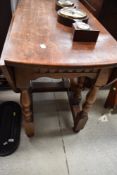 A traditional oak gateleg dining table on turned frame