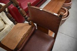 A pair of mid 20th Century stained frame dining chairs having rexine studded seats and backs