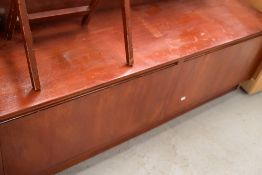 A low drop fronted side or similar sideboard having had repair to door