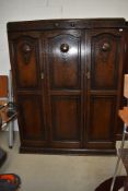 An early 20th Century oak triple wardrobe, dimensions approx. W150cm H195cm D52cm