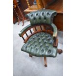 A reproduction button back green leather office chair