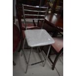 A vintage style chrome frame kitchen bar stool with vinyl seat