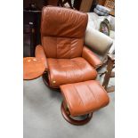 A Stressless chair and footstool, tan leather