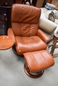 A Stressless chair and footstool, tan leather