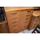 A 1970s style teak bedroom chest of five graduated drawers, labelled inside drawer William