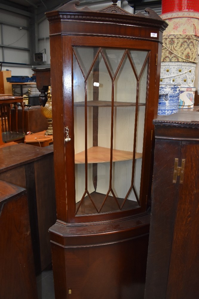 A reproduction Regency corner display cabinet with cupboard under