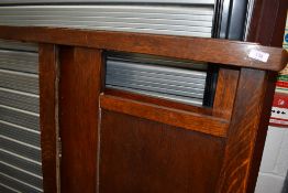 An early 20th Century oak double bed frame including irons, no base or mattress