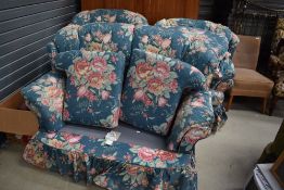 A late 1980s three piece suite having floral covers