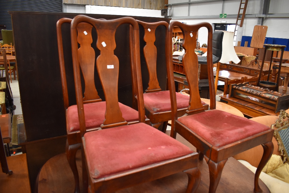 A set of four early 20th Century Queen Anne style mahogany dining chairs having vase backs and