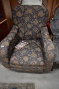 A nice quality early 20th Century low seat armchair having blue foliate upholstery