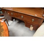An early 20th Century mahogany and inlaid dressing table/kneehole desk, on square tapered legs,