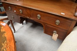 An early 20th Century mahogany and inlaid dressing table/kneehole desk, on square tapered legs,