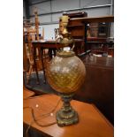 An antique ormolou lamp having detailed cast base with textured yellow glass balloon body