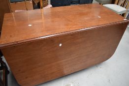 A Victorian mahogany gateleg dining table on turned legs with brass castors, width approx.123cm,