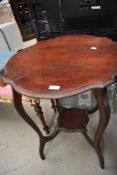 An early 20th Century mahogany occasional table having shaped top, legs and undertier, width approx.