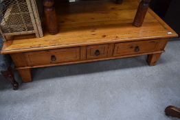 A modern stripped pine coffee table with side drawer, dimensions approx. 140 x 75cm, height 43cm