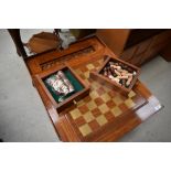 A modern hardwood occasional games table having brass inlay decoration, and reversible lid with