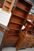 An early 20th Century mahogany narrow bookcase having double drawer base