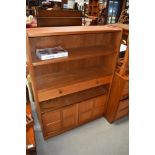 A teak Nathan bookshelf of shallow proportions with drawers and cupboard section