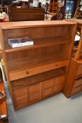 A teak Nathan bookshelf of shallow proportions with drawers and cupboard section