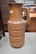 A vintage German floor vase in jug form, sadly base is damaged and been repaired, height approx.