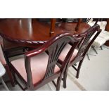A reproduction Regency style dining table and set of six (four plus two) dining chairs