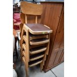 A set of five vintage (1950s/1960s) bentwood and ply stacking chairs having brown vinyl seats,