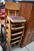 A set of five vintage (1950s/1960s) bentwood and ply stacking chairs having brown vinyl seats,