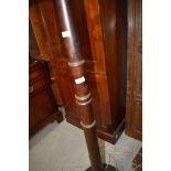 A mahogany standard lamp having turned column