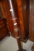 A mahogany standard lamp having turned column