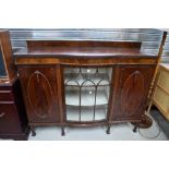 An early 20th Century demi bow fronted display cabinet with central glazed section being flanked