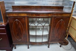 An early 20th Century demi bow fronted display cabinet with central glazed section being flanked